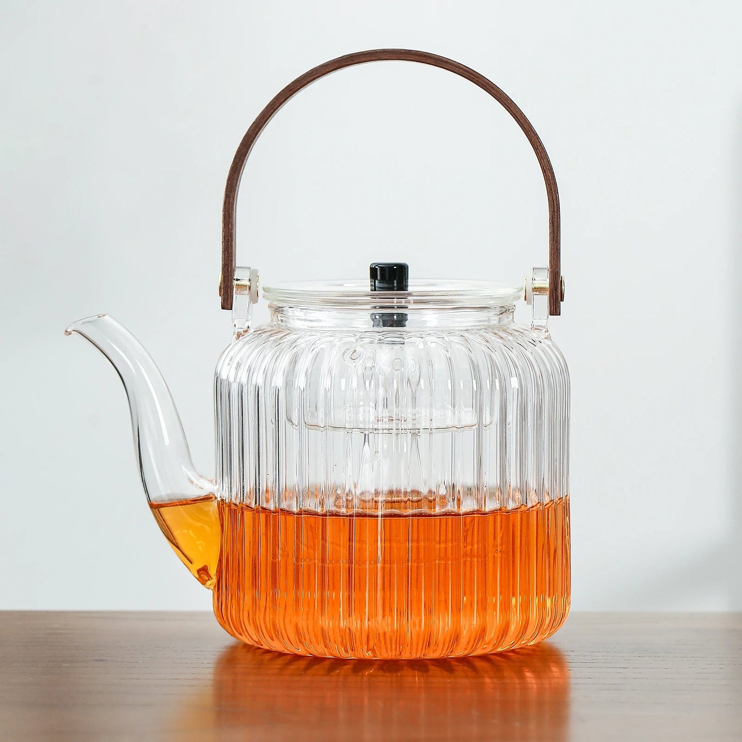 https://www.teanagoo.com/cdn/shop/products/Heat-Resistant_Glass_Teapot_with_Infuser_Lid_and_Wood_Handle_for_Loose_Leaf_Tea_and_Blooming_Tea_TP04-01.jpg?v=1668492807&width=1445